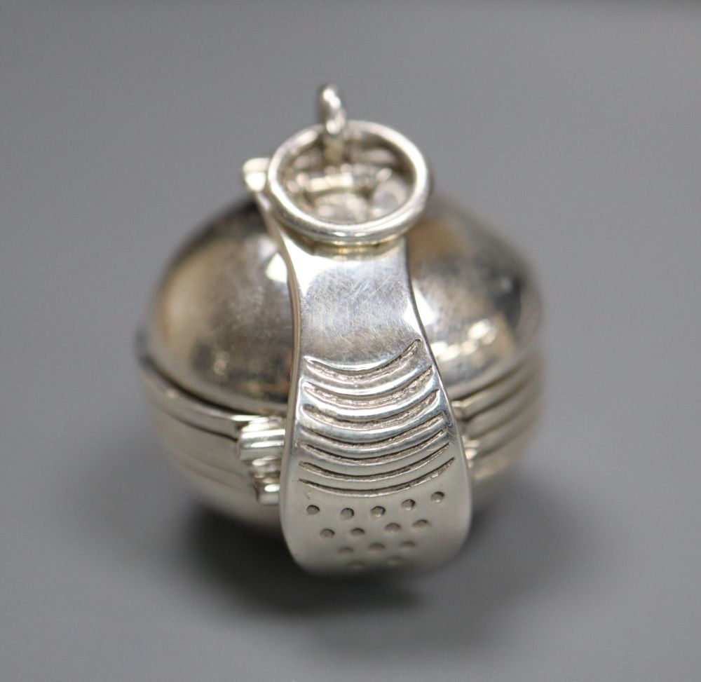 A modern 925 metamorphic hinged sphere pendant, opening to reveal four miniature photograph frames, 27mm.